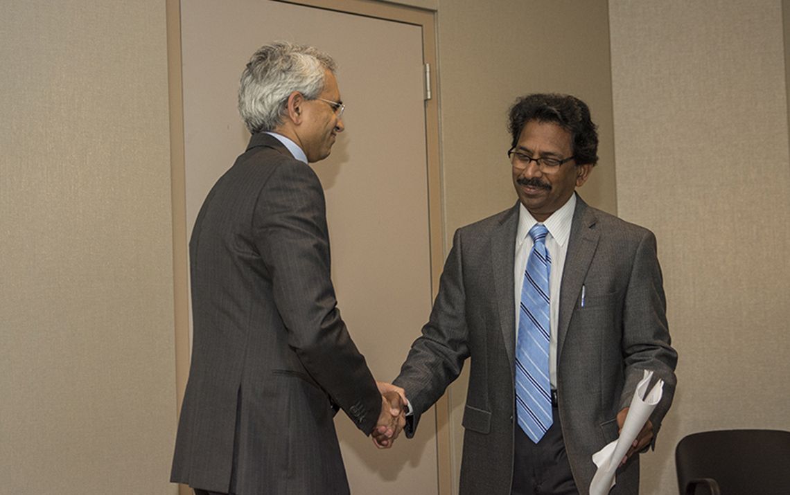 Raj shaking hands with someone